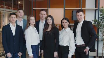 Students show likes and smiles. Portrait of a group of students who are in the room and smiling at the camera video
