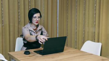 Successful woman working remotely at home. The freelancer opens a nice top and enjoys working at home. A business lady works on a laptop and demonstrates positive emotions while working at a computer. video
