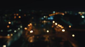 blurred night city background with colored bokeh. View of the city from a height out of focus. video