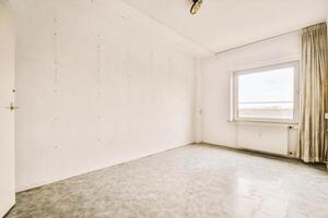 An empty room with a window and a door photo