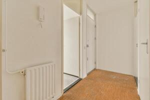 A hallway with a radiator and a door photo