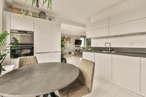 A kitchen with a table and chairs in it photo