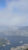 Panoramic view from the top of the mountain to the Bay of Kotor and the old town of Kotor in Montenegro.foggy haze on a hot sunny day video