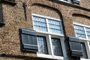 Window with shutters on a medieval building in the netherlands photo