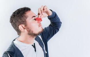 Concept of nasal congestion and nosebleed. Person with nosebleed isolated photo