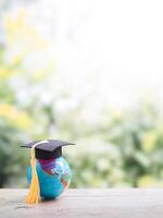 Earth globe with graduation hat on the table with nature as background. Copy space for text, Back to school, Education concept photo