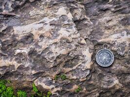Compass on the rock. The concept of world tourism day, Searching the right directions and Travel photo