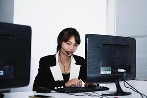 call center smiling business operator customer support team phone services agen working and talking with headset on desktop computer at call center photo