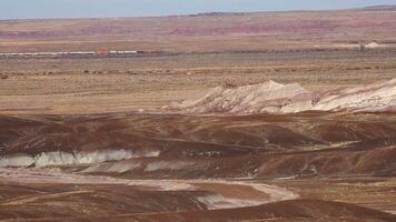Petrified Forest National Park, Erosion of ancient multi-colored sedimentary rocks from which fossilized sequoias are washed away video