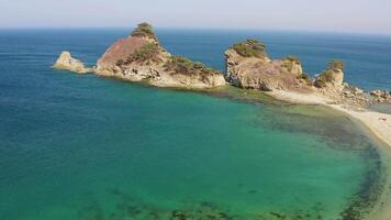 Rocky promontory with a strait between the rocks. Untouched nature. Drone view video
