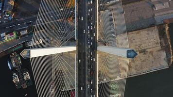 Vertically down view on the road with dense traffic of the cable-stayed bridge video