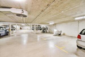 An empty parking garage with two cars parked in it photo