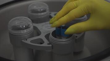 Test tubes are getting inserted into a biochemical analyzer by a lab worker video