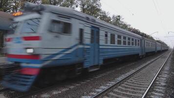 Passenger rail transport passes the camera and arrives at the station. Transportation by rail of a large number of travelers video