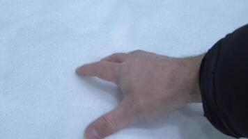 On a winter day, a mans hand takes white cold snow video