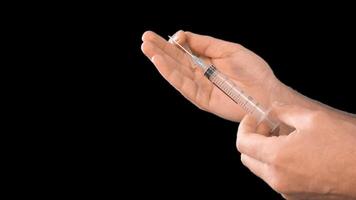 Alpha channel. Male hands presenting a syringe in their hands fill it with medicine or a vaccine taking it from a glass flask for use in the treatment of diseases video