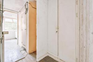 A hallway with a door and a door knob photo