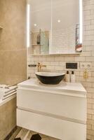 A bathroom with a sink, mirror and toilet photo