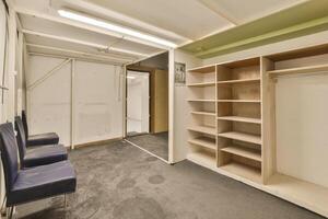A room with a closet and a bench in it photo