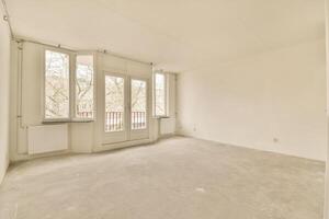 An empty room with a large window and a door photo