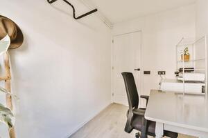 A small office with a desk and chair photo