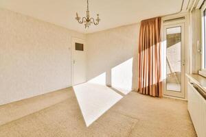 A room with a chandelier and a window photo