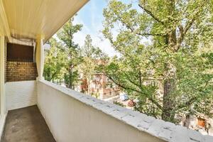 A balcony with trees and a view of the street photo