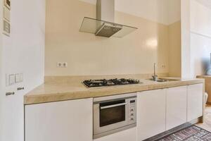 A kitchen with a stove, oven, sink and microwave photo