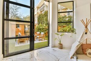 A white room with a teepee and patio furniture photo