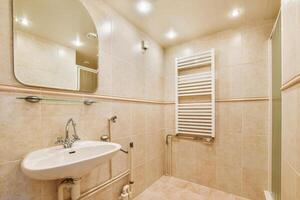 A bathroom with a sink and a towel rack photo
