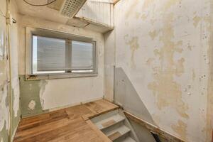 An empty room with a wooden floor and a window photo