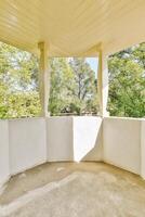 A porch with a white roof and columns photo