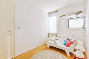 A small room with a white bathtub and a toy rabbit photo