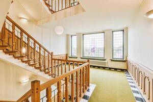A staircase in a building with a checkered floor photo
