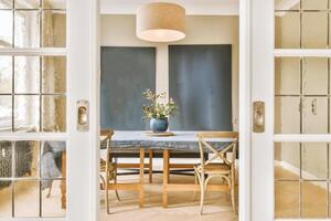 A dining room with a table and chairs photo
