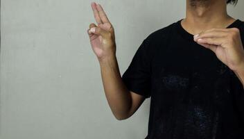 young man using sign language interpreter to communicate photo