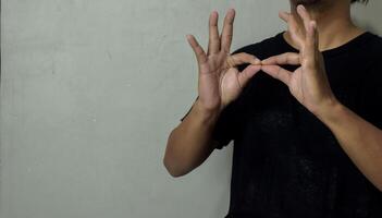 young man using sign language interpreter to communicate photo