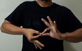 young man using sign language interpreter to communicate photo