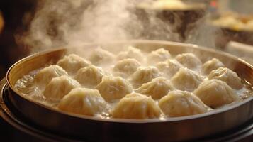 Steaming dumplings in a bamboo steamer at a bustling kitchen during dinner time photo