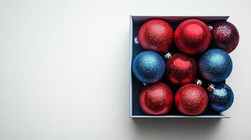 Festive holiday ornaments arranged in a box with pine branches and pine cones during winter season photo