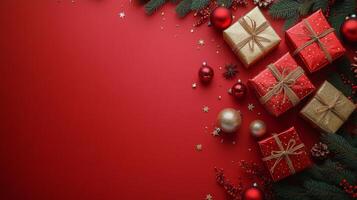 Beautifully wrapped Christmas gifts on a festive red background with decorations and greenery photo