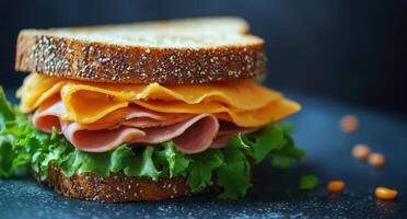 A hearty sandwich with layers of ham, cheese, and fresh lettuce on whole grain bread photo