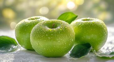 Freshly washed green apples resting on leaves with morning dew in a bright, natural setting photo