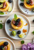 Delicious fruit tart with figs, blackberries, and lime on a wooden table photo