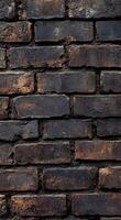 Textured dark brick wall with rusty highlights showing age and character in an urban setting photo
