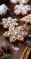 Homemade snowflake-shaped cookies decorated with icing on a wooden surface with spices photo