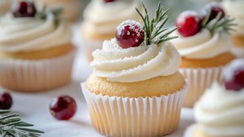 Delicious holiday vanilla cupcakes decorated with cranberries and rosemary on a festive table photo