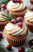 Festive cupcakes topped with cream frosting and cranberries on a winter day photo