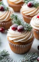 Festive cupcakes topped with cream frosting and cranberries on a winter day photo