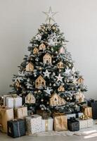 Beautifully decorated Christmas tree with handmade ornaments and neatly wrapped gifts underneath photo